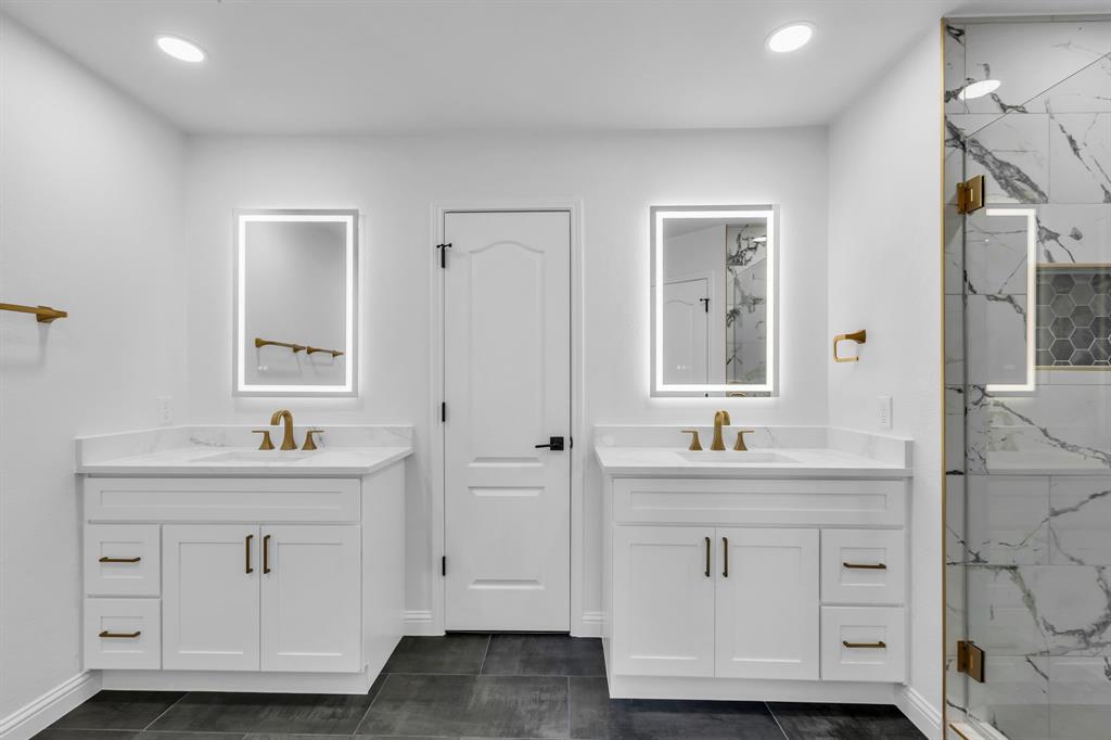 906 Thistle Circle Allen, TX 75002 - Photo 23 of 40 a bathroom with a double vanity sink and mirror
