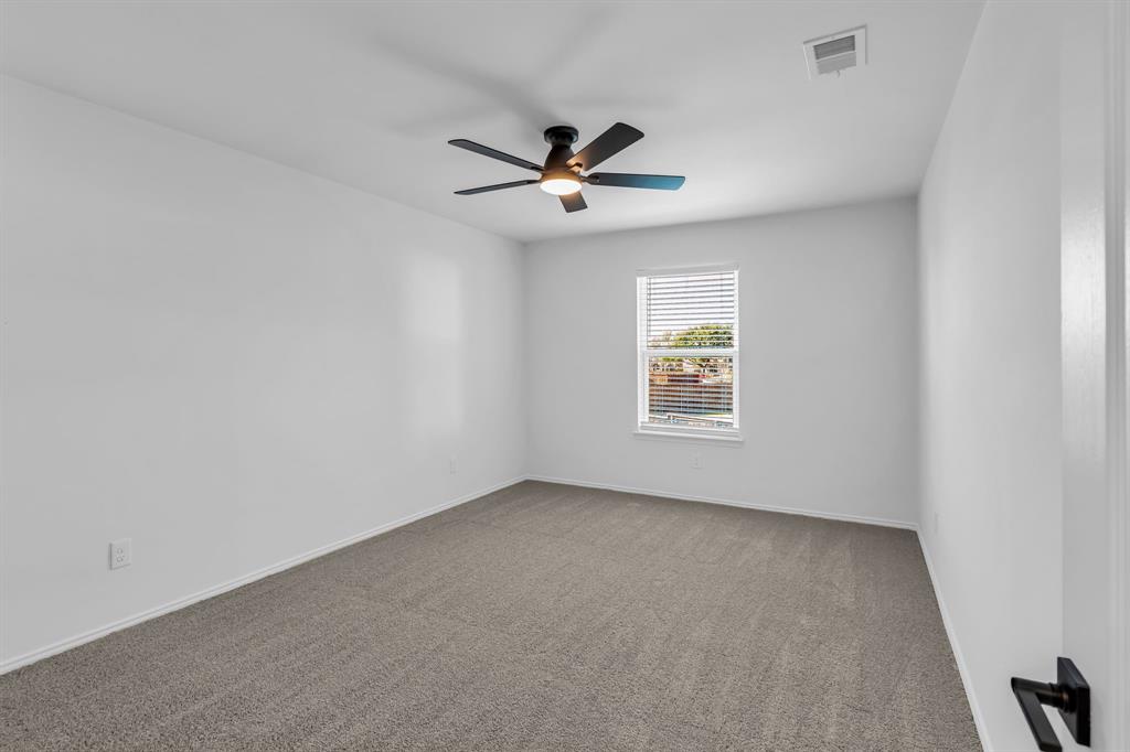 906 Thistle Circle Allen, TX 75002 - Photo 32 of 40 an empty room with windows and fan
