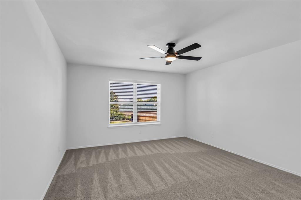 906 Thistle Circle Allen, TX 75002 - Photo 33 of 40 an empty room with a window and a fan