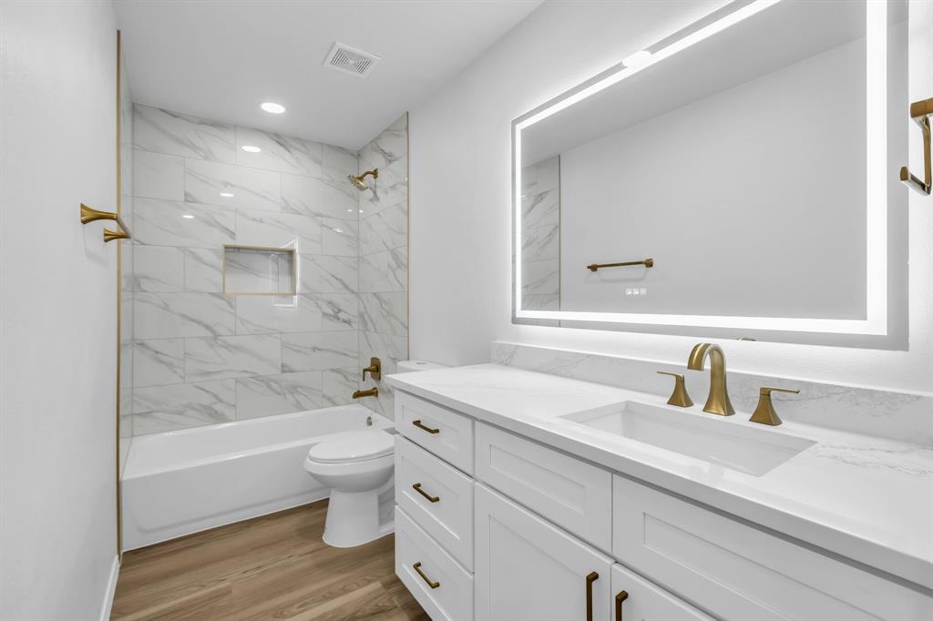 906 Thistle Circle Allen, TX 75002 - Photo 34 of 40 a bathroom with a sink a toilet and shower