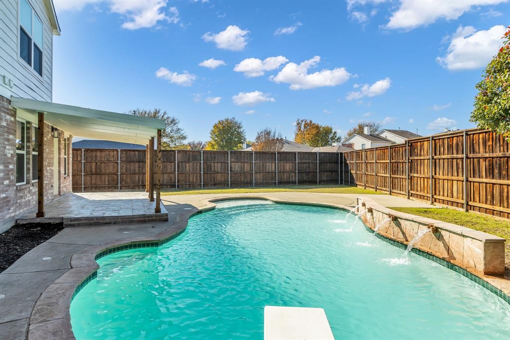 906 Thistle Circle Allen, TX 75002 - Photo 40 of 40 a view of a swimming pool with a lounge chair and a fire pit