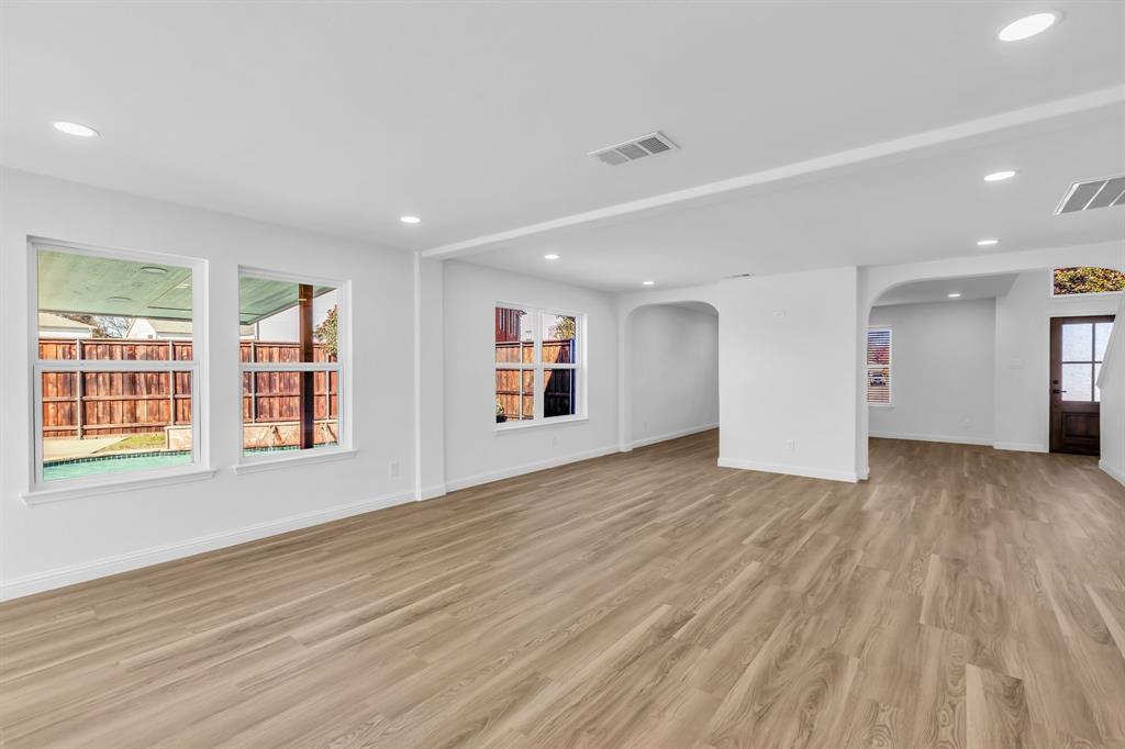 906 Thistle Circle Allen, TX 75002 - Photo 10 of 40 a view of an empty room with wooden floor and a window