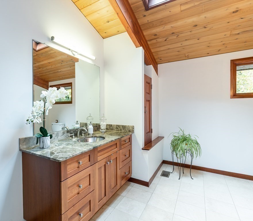12 Rice Spring Lane Wayland, MA 01778 - Photo 19 of 37 a bathroom with a granite countertop sink and a mirror