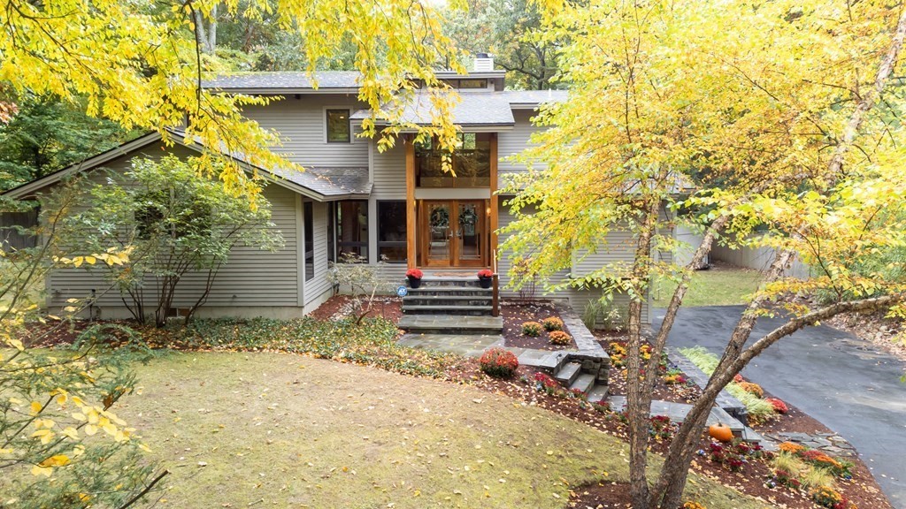 12 Rice Spring Lane Wayland, MA 01778 - Photo 2 of 37 a backyard of a house with large trees and plants