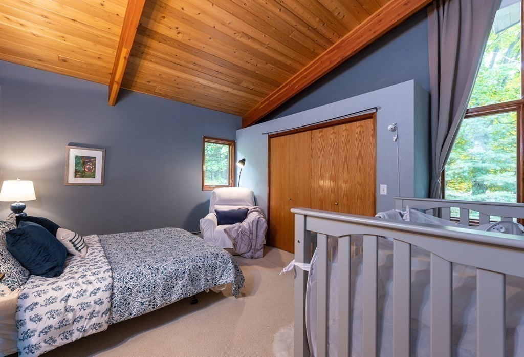 12 Rice Spring Lane Wayland, MA 01778 - Photo 24 of 37 a bedroom with a bed and wooden floor