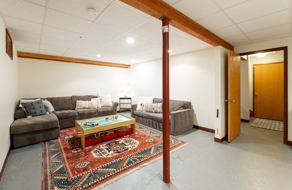 12 Rice Spring Lane Wayland, MA 01778 - Photo 28 of 37 a living room with furniture and a floor to ceiling window