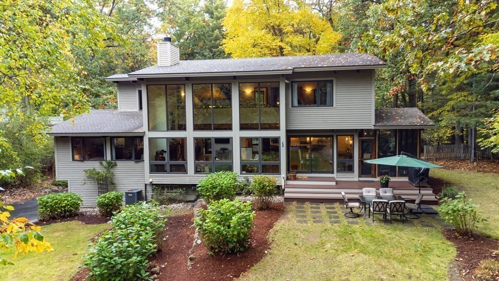 12 Rice Spring Lane Wayland, MA 01778 - Photo 34 of 37 a front view of a house with swimming pool table and chairs