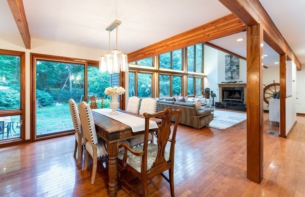 12 Rice Spring Lane Wayland, MA 01778 - Photo 8 of 37 a view of a dining room with furniture large windows and wooden floor