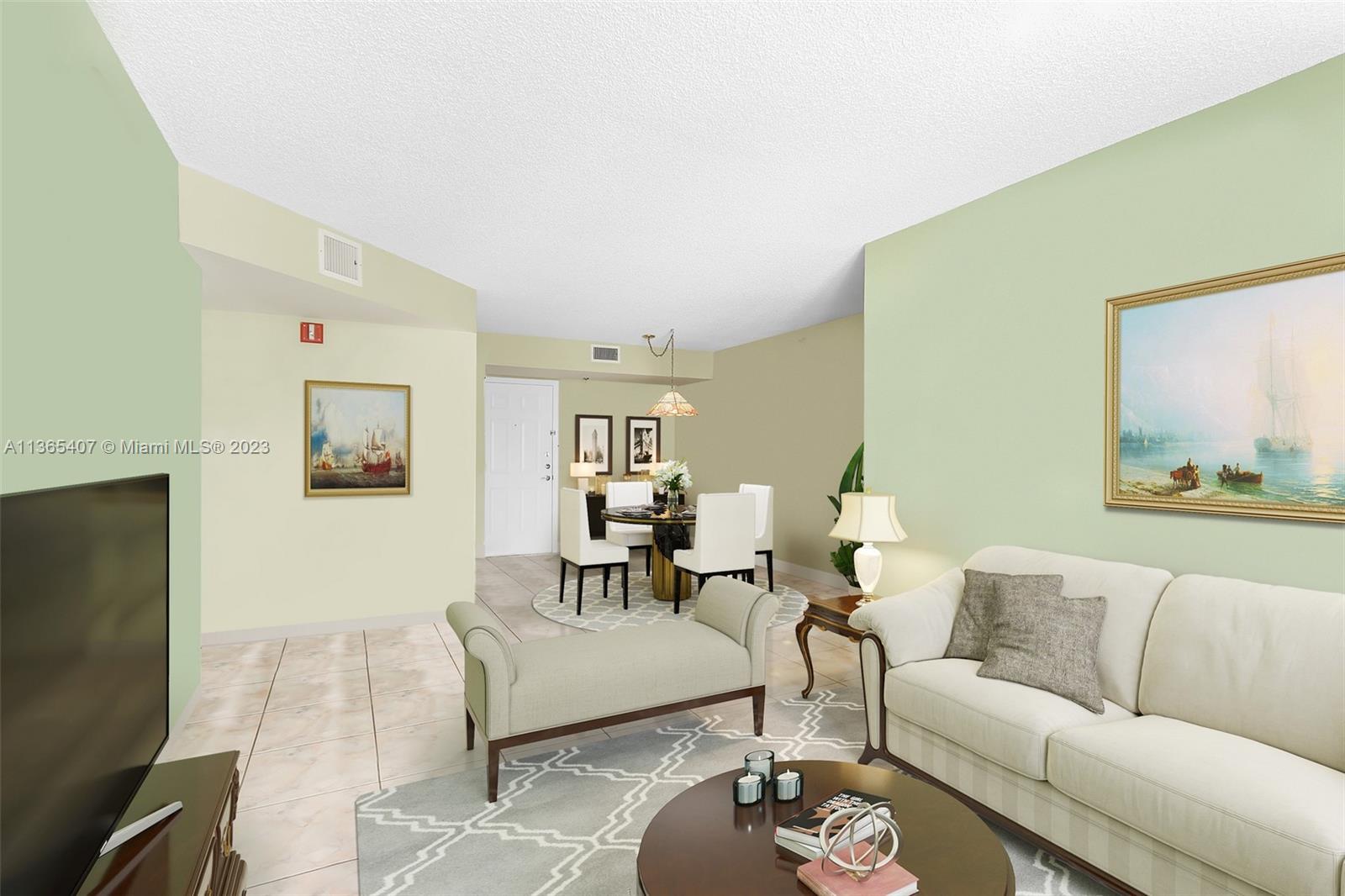 1621 Bay Road, Unit 605 Miami Beach, FL 33139 - Photo 2 of 15 a living room with furniture and a flat screen tv