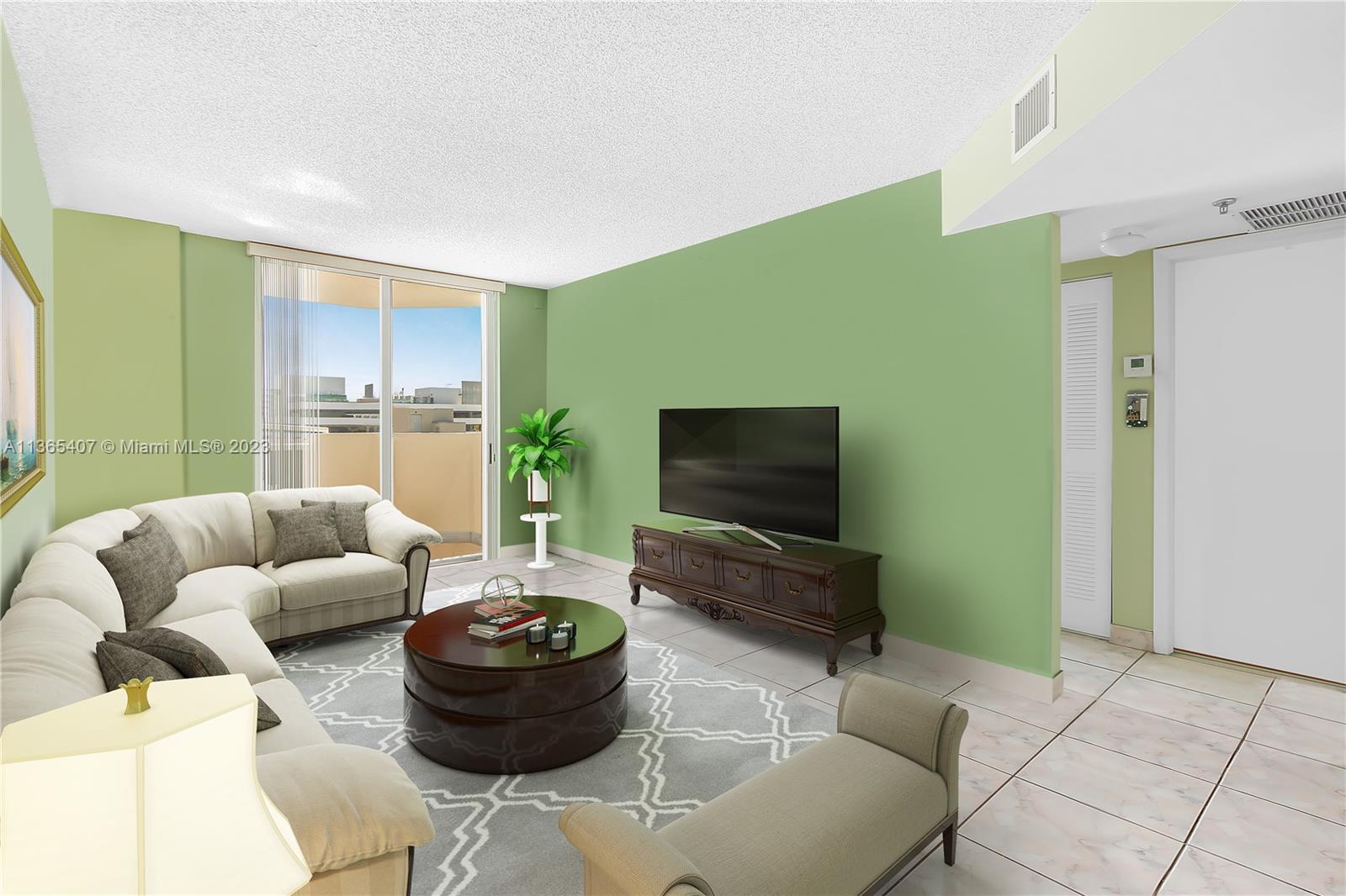 1621 Bay Road, Unit 605 Miami Beach, FL 33139 - Photo 3 of 15 a living room with furniture and a flat screen tv