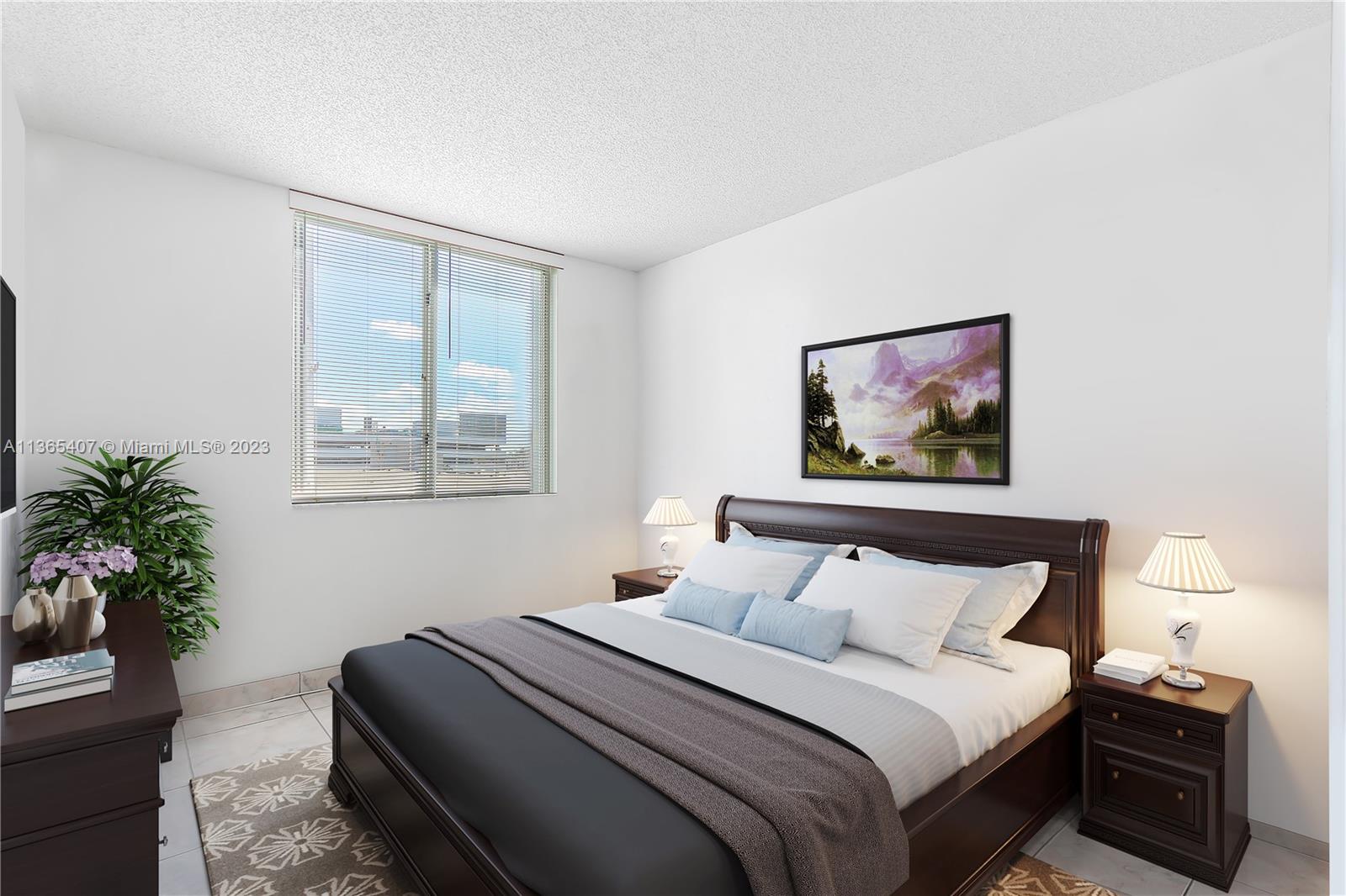 1621 Bay Road, Unit 605 Miami Beach, FL 33139 - Photo 6 of 15 a bedroom with bed painting on the wall and a potted plant