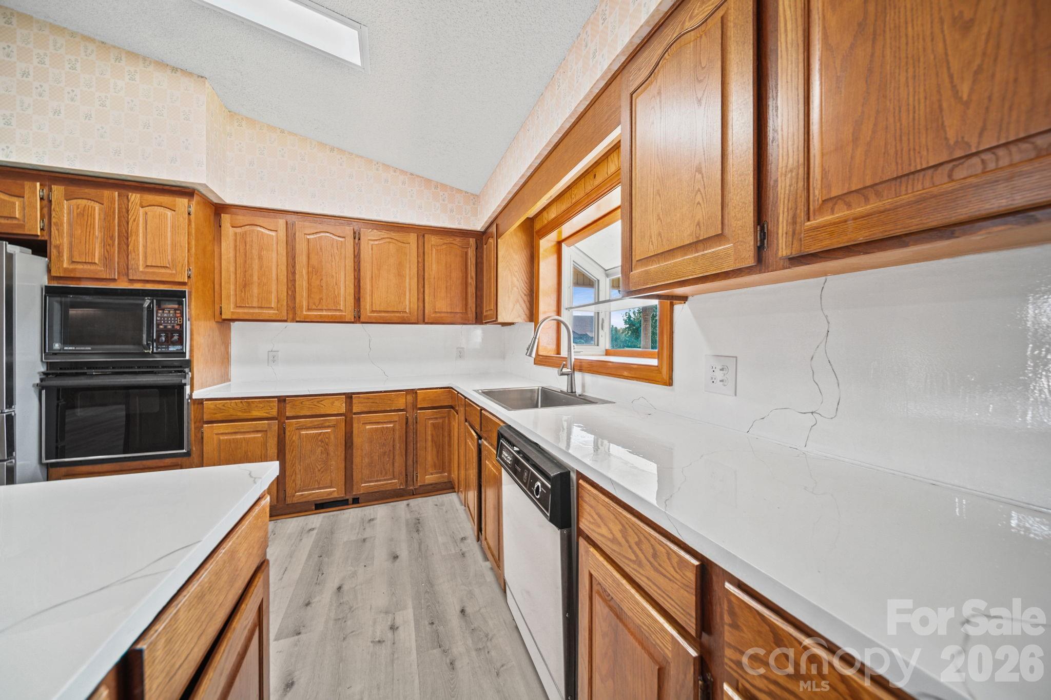 235 Spring Estates Circle Salisbury, NC 28146 - Photo 14 of 47 a kitchen with stainless steel appliances granite countertop a sink a stove and cabinets