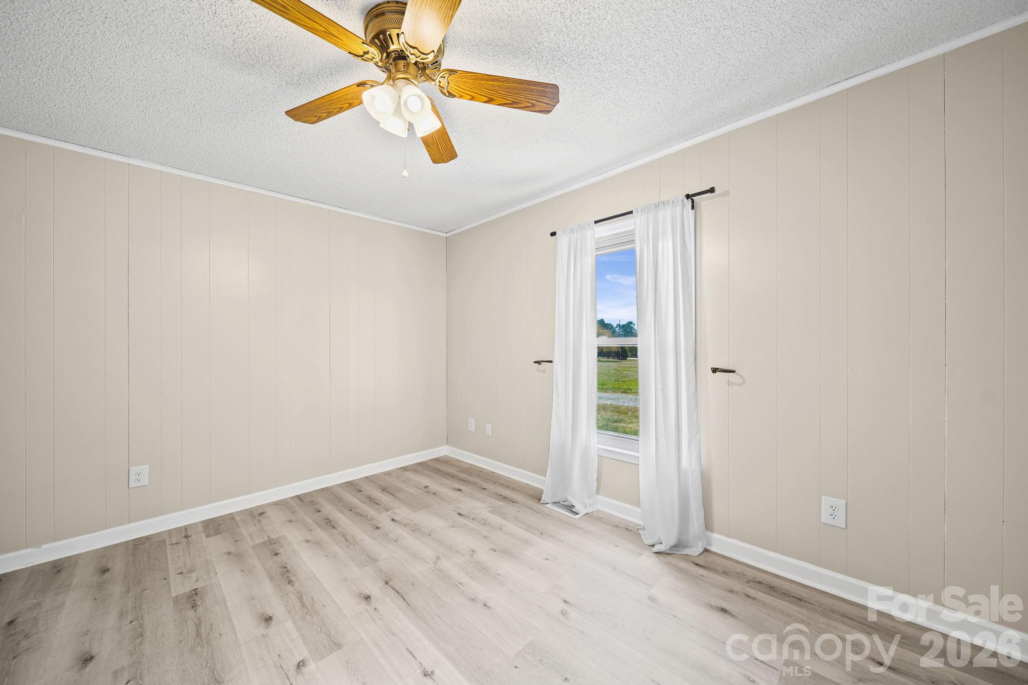 235 Spring Estates Circle Salisbury, NC 28146 - Photo 24 of 47 an empty room with a ceiling fan and carpet