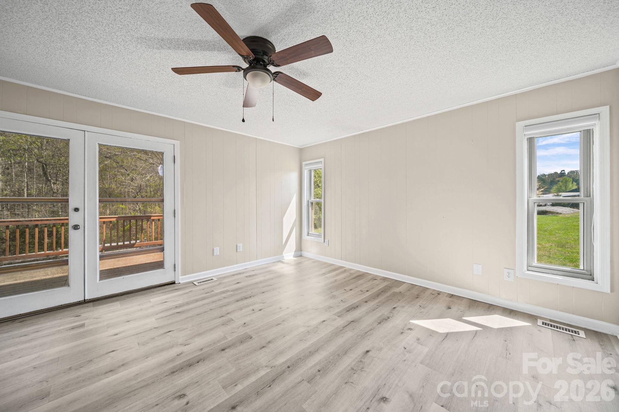 235 Spring Estates Circle Salisbury, NC 28146 - Photo 29 of 47 an empty room with wooden floor fan and windows