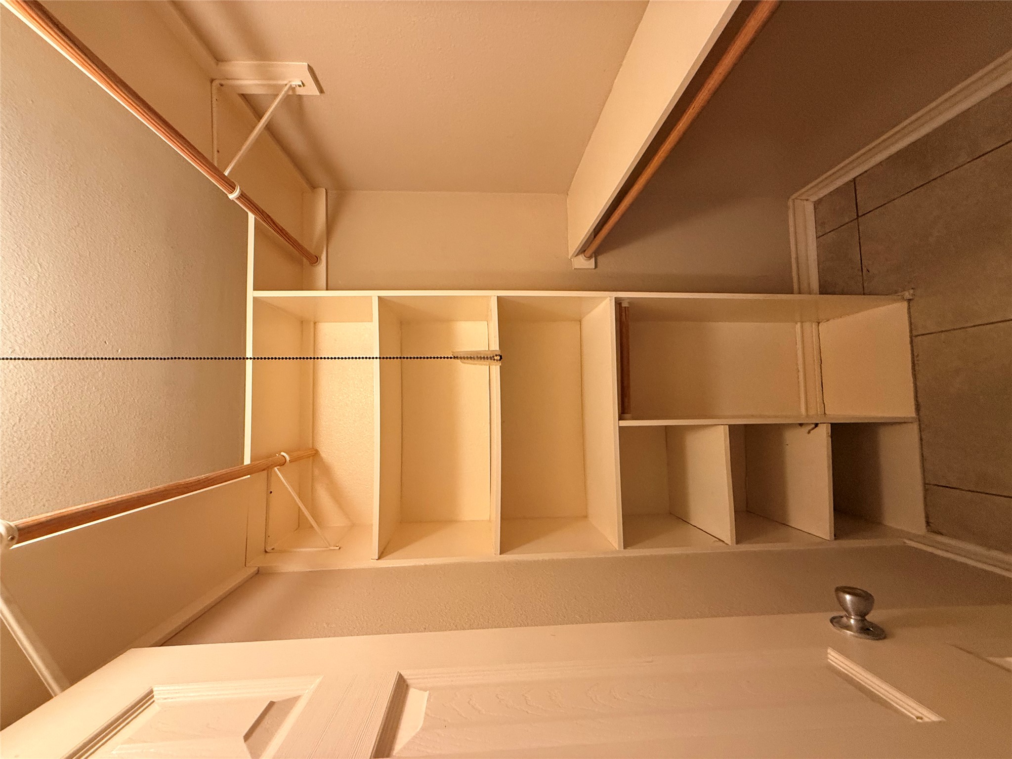 407 East 45th Street, Unit 104 Austin, TX 78751 - Photo 4 of 14 a view of walk in closet with empty racks