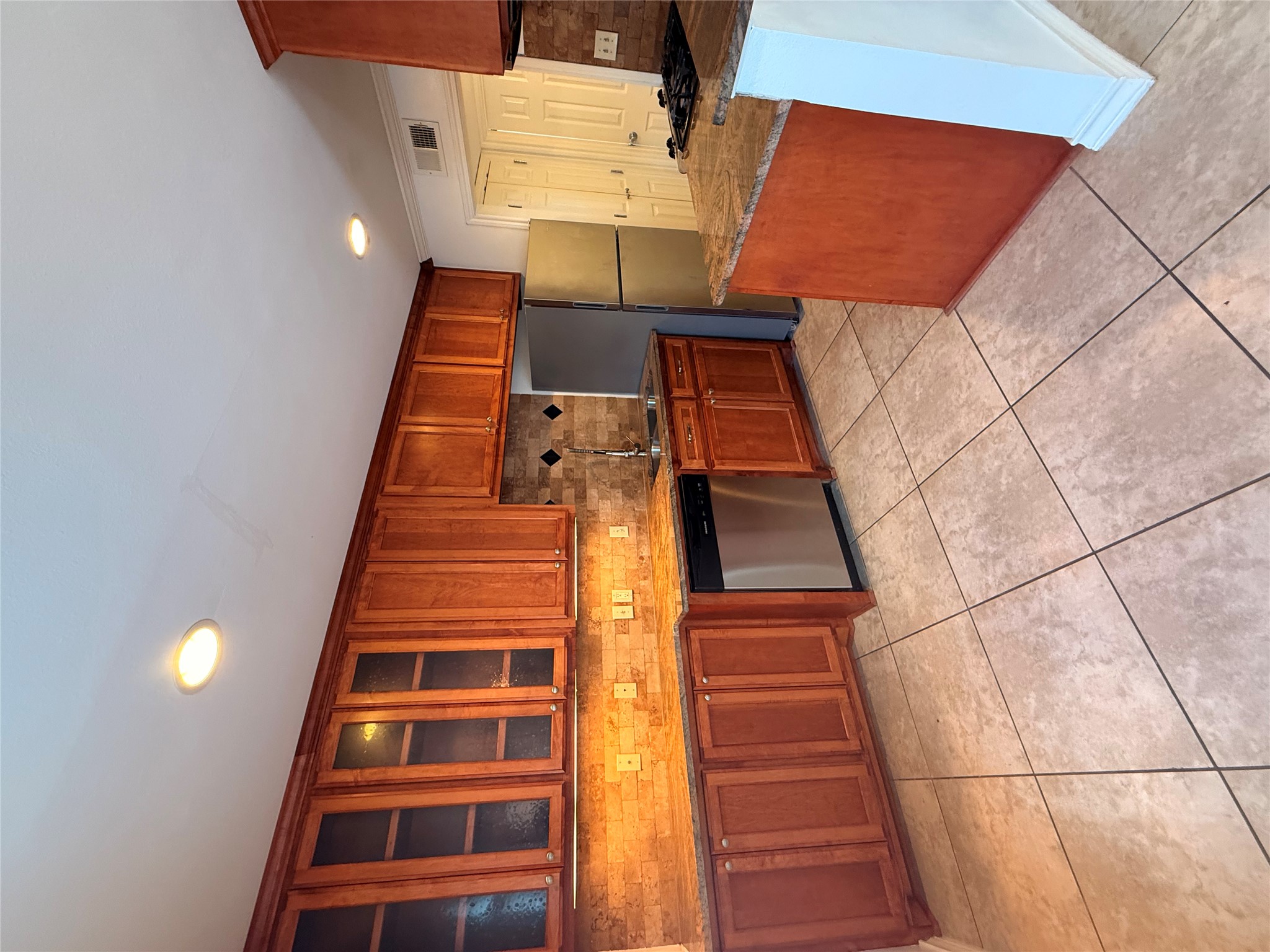 407 East 45th Street, Unit 104 Austin, TX 78751 - Photo 6 of 14 a kitchen with stainless steel appliances granite countertop a stove top oven a sink dishwasher and a refrigerator
