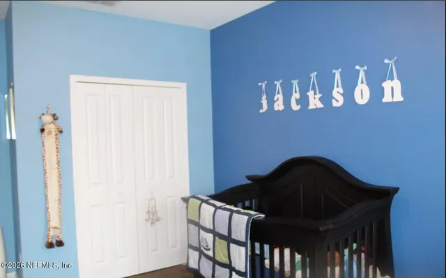a black room with a book shelf and a window