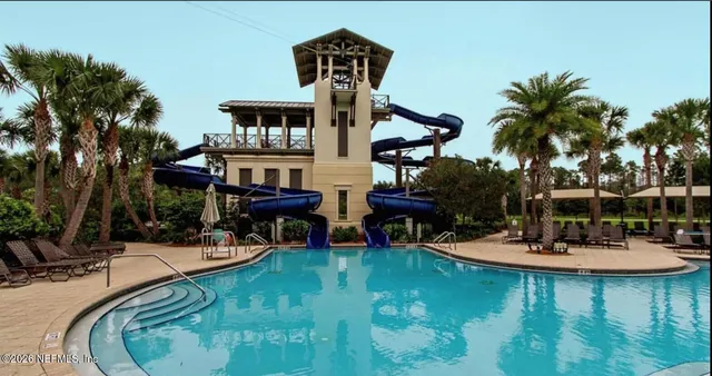 a view of a house with backyard porch and sitting area