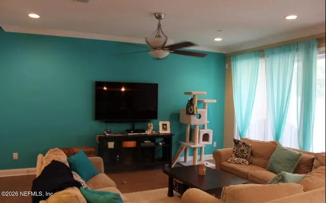 a living room with furniture and a flat screen tv