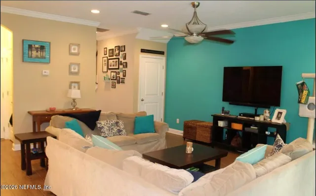 a living room with furniture and a flat screen tv