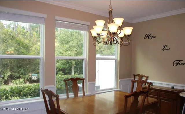 a view of a dining room with furniture window and outside view