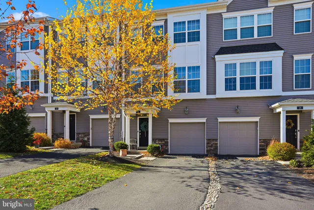 a front view of a building with many windows and yard