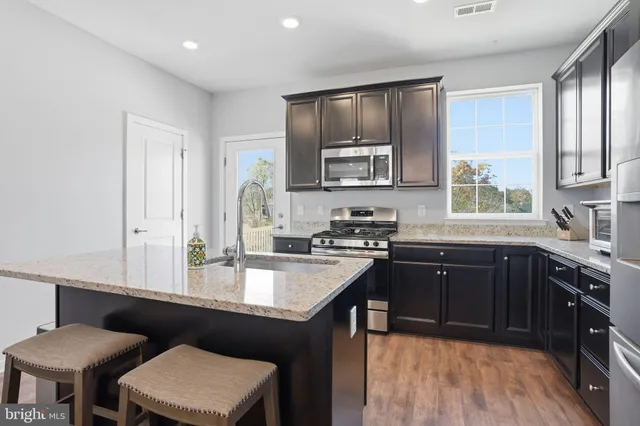a kitchen with a stove a sink and a refrigerator