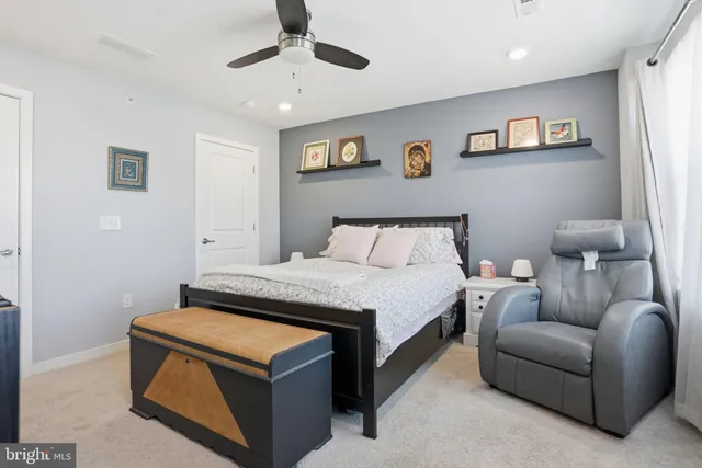 a bedroom with a bed and ceiling fan