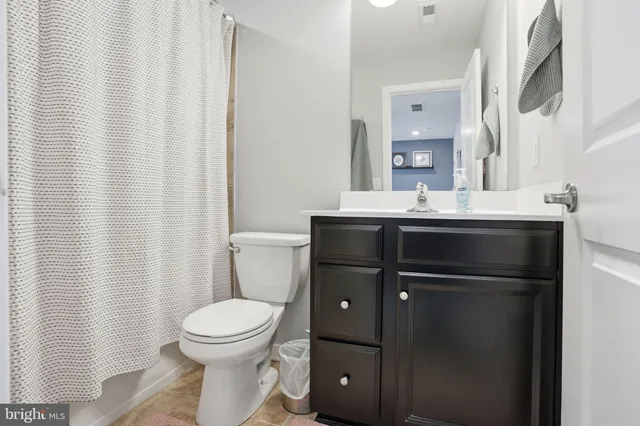 a bathroom with a toilet a sink and a mirror