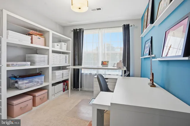 a kitchen with a table chairs and a refrigerator