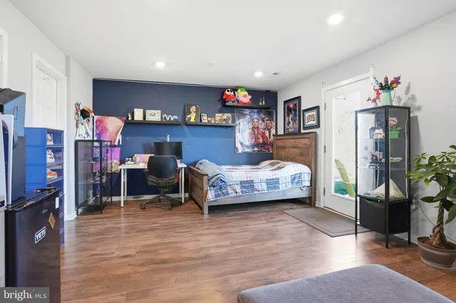 a bedroom with furniture and a wooden floor