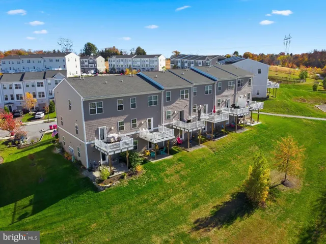 a view of a house with a big yard and large trees