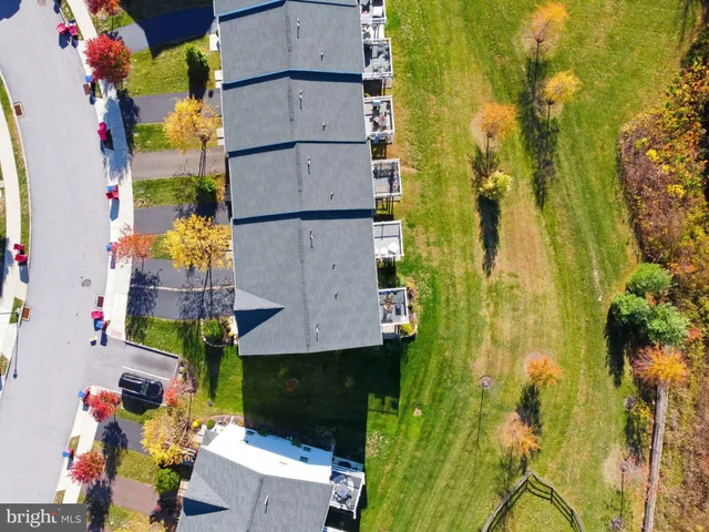 an aerial view of residential houses with yard