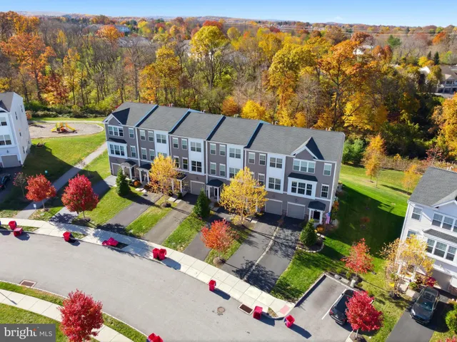 an aerial view of a houses with a swimming pool