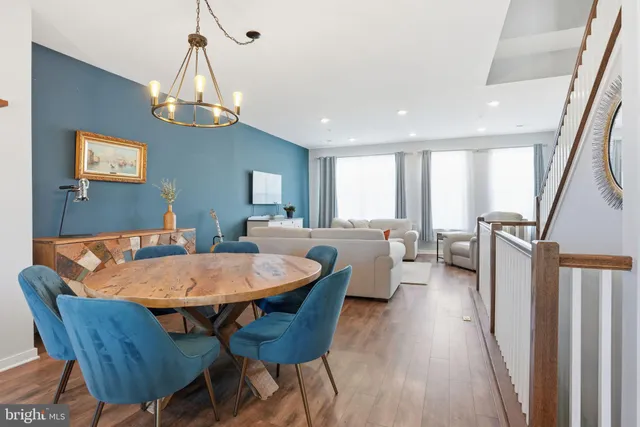a view of a dining room with furniture wooden floor and chandelier