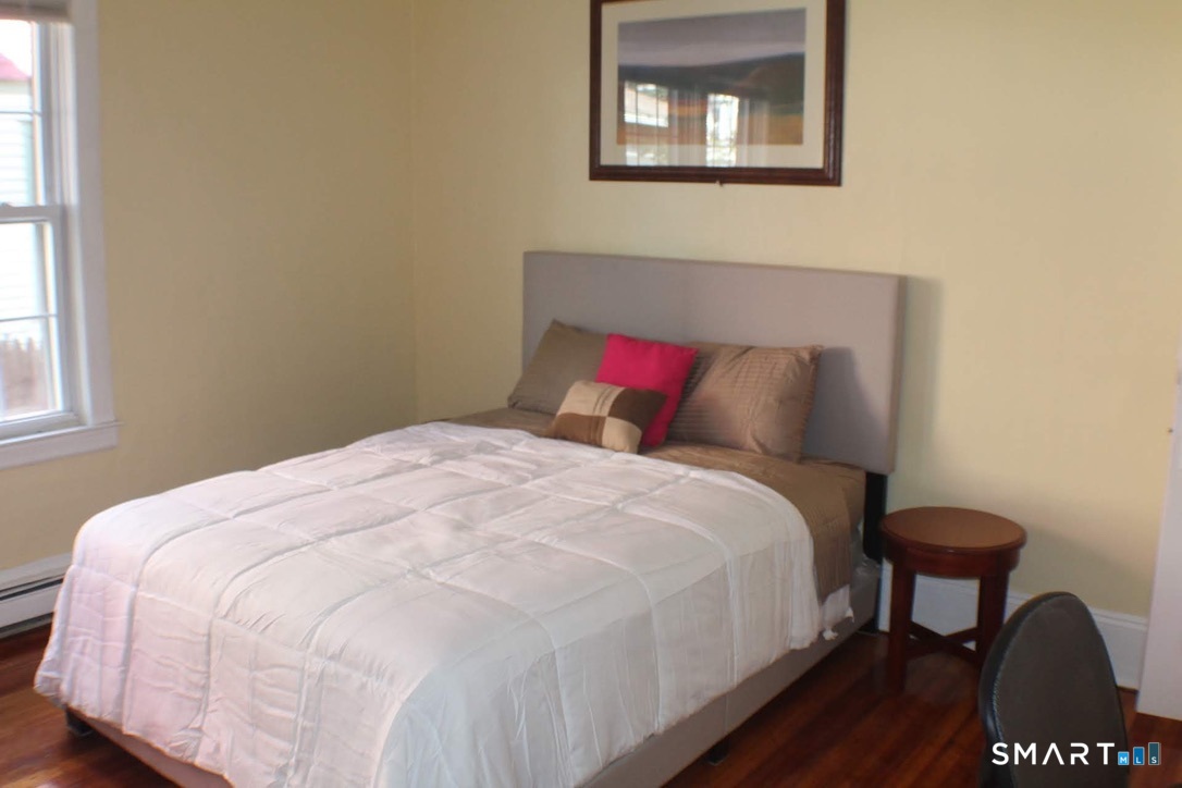 150 Whitney Street Hartford, CT 06105 - Photo 2 of 39 a bedroom with a bed and a window