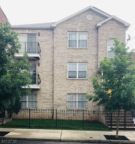 a view of a brick building and many windows