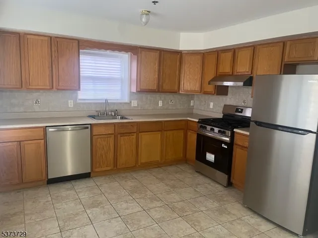 a kitchen with a sink a stove and refrigerator
