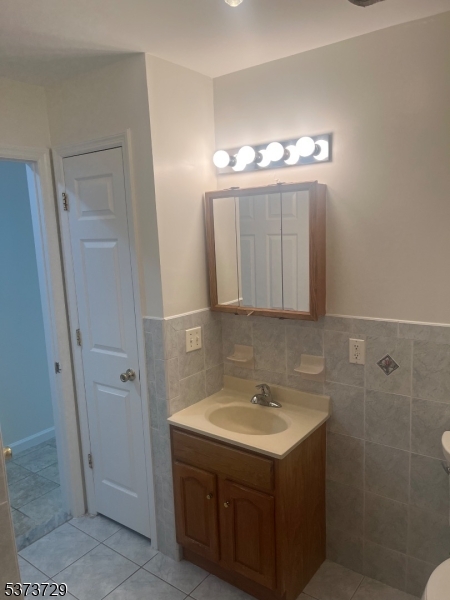98 Quitman Street Newark, NJ 07102 - Photo 9 of 15 a bathroom with a sink vanity and a mirror