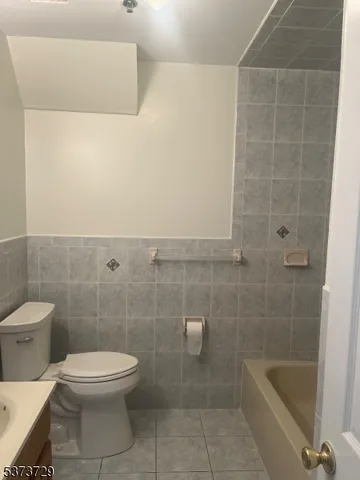 a bathroom with a toilet a sink and bathtub