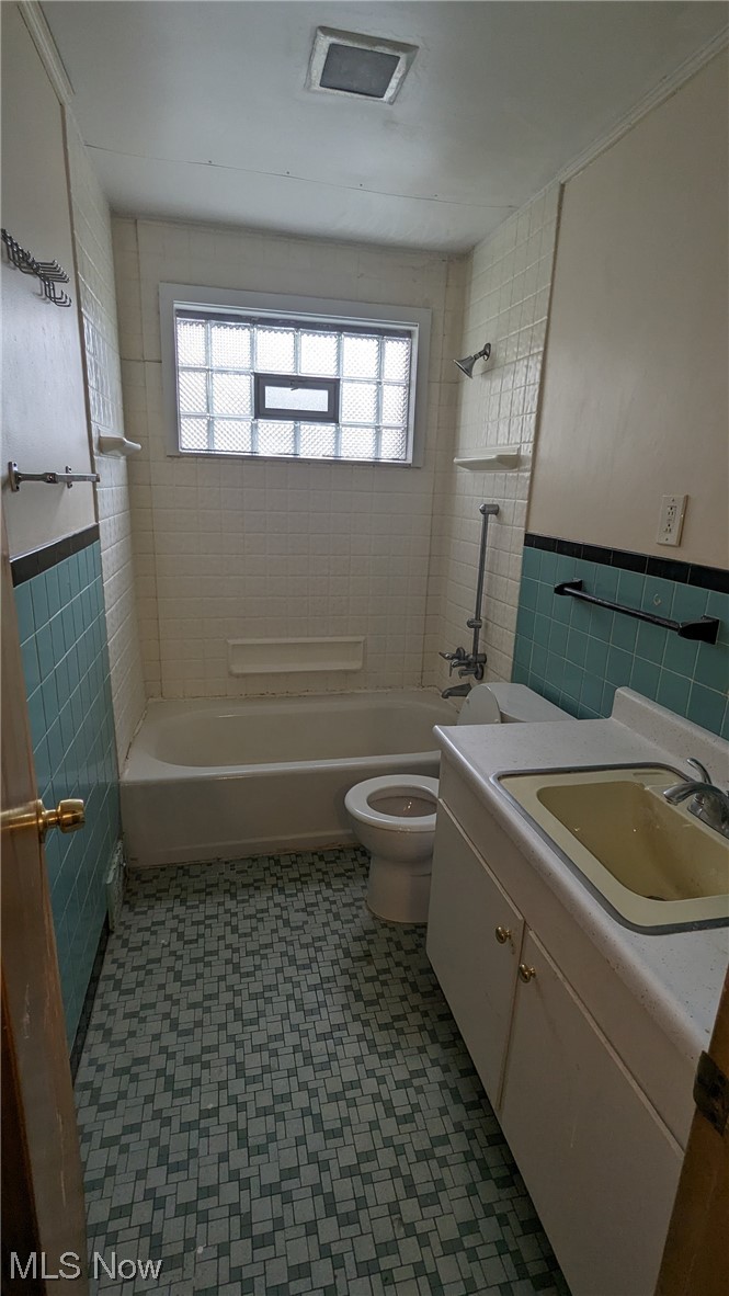 1470 Babbitt Road Euclid, OH 44117 - Photo 18 of 34 Full bathroom featuring tile flooring, a healthy amount of sunlight, toilet, and tiled shower / bath