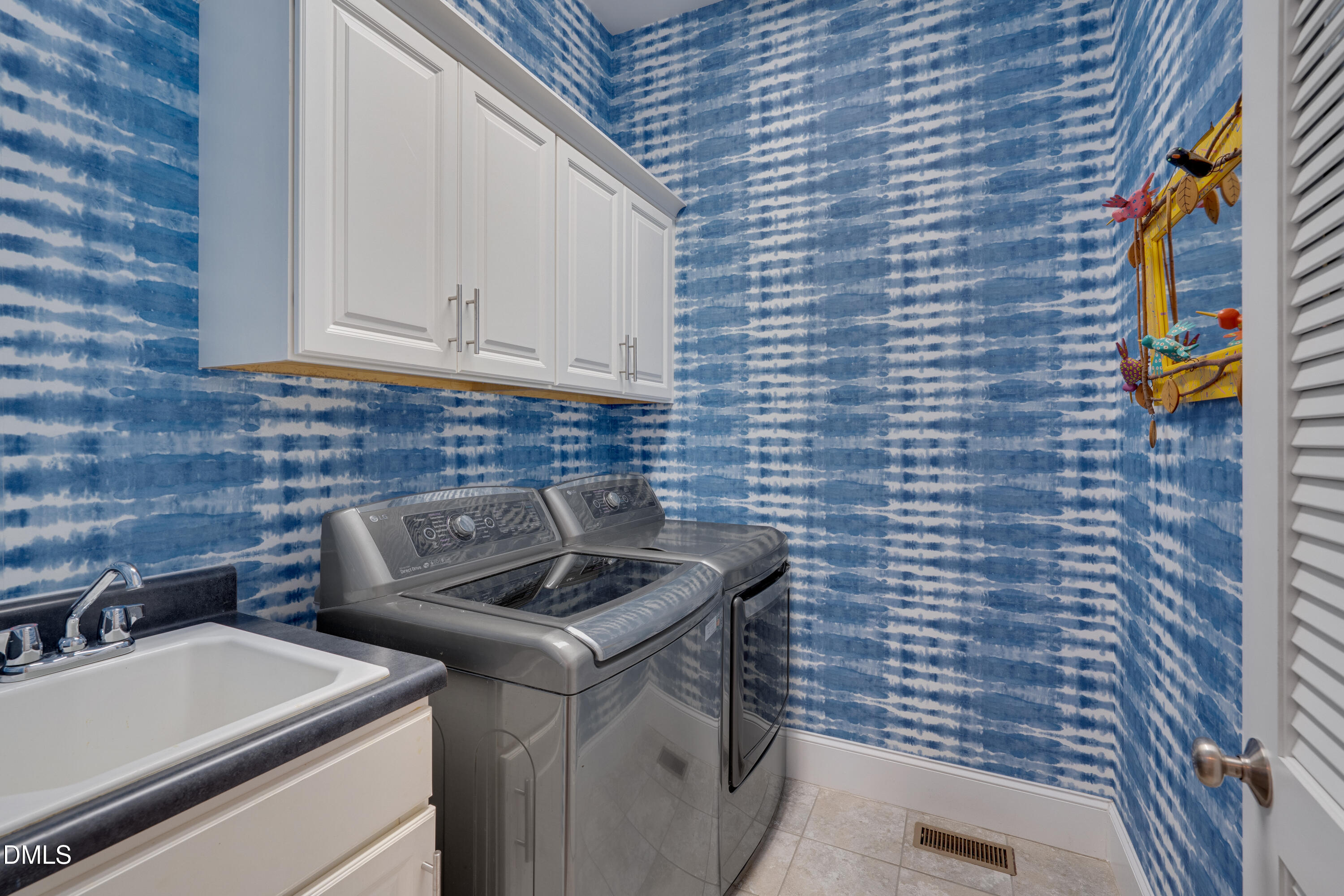 8027 Brandyapple Drive Raleigh, NC 27615 - Photo 34 of 52 Laundry room with utility sink and cabinetry