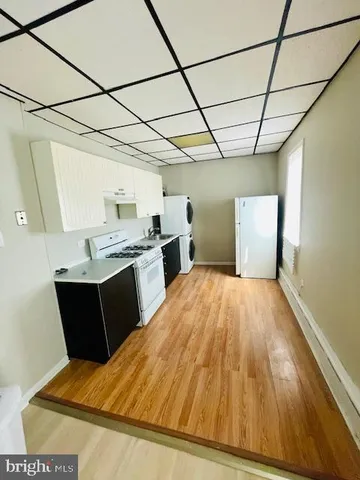 a kitchen with a wooden floor and window
