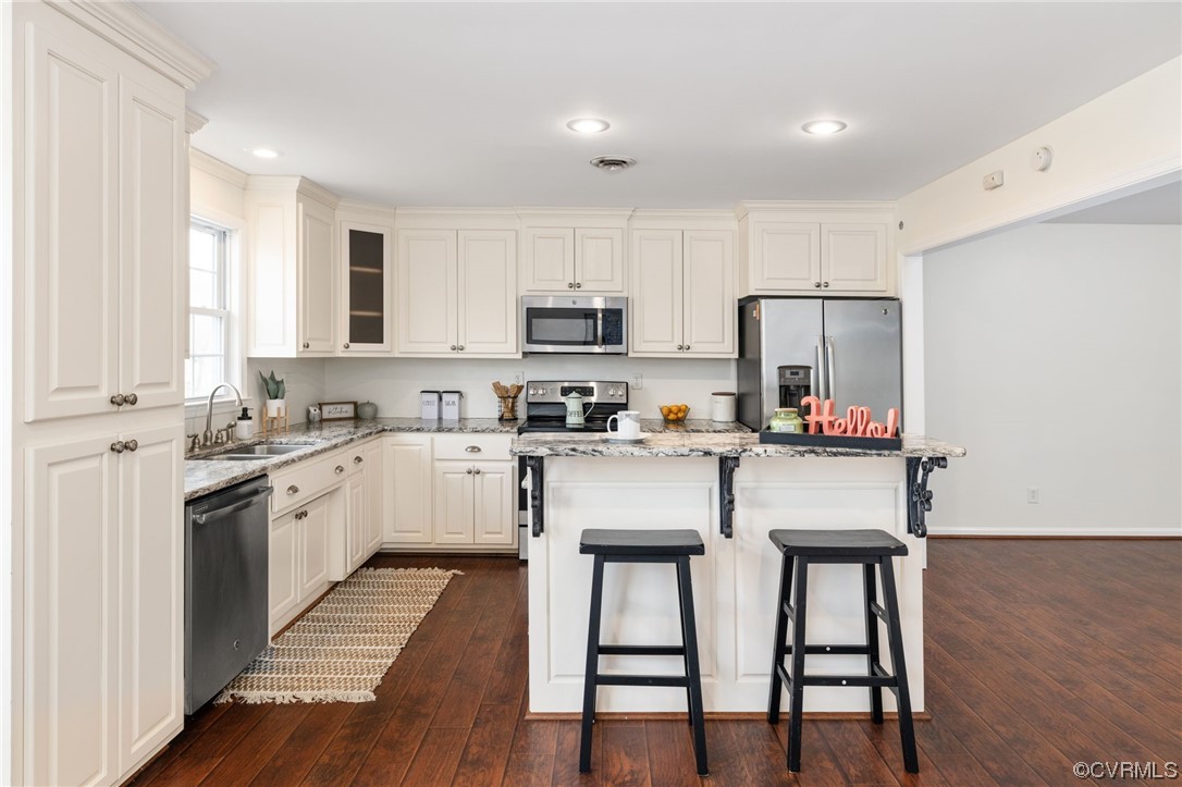3612 Chesdin Boulevard Sutherland, VA 23885 - Photo 11 of 44 a kitchen with a white cabinets and chairs