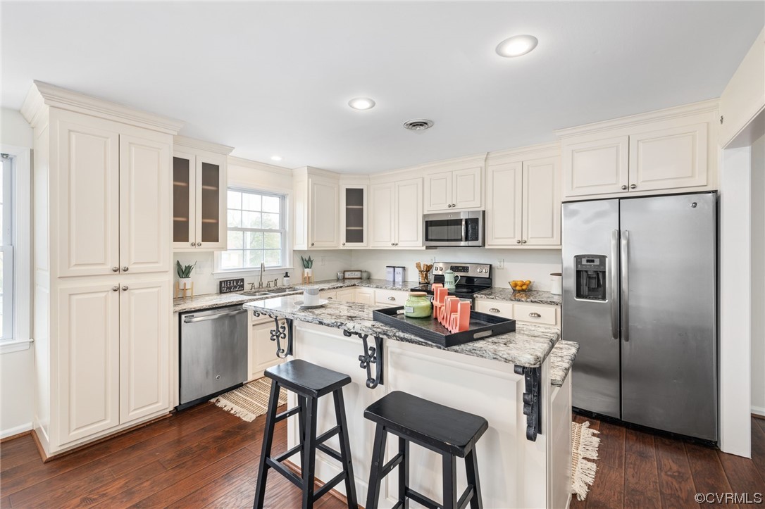 3612 Chesdin Boulevard Sutherland, VA 23885 - Photo 12 of 44 a kitchen with white cabinets and stainless steel appliances