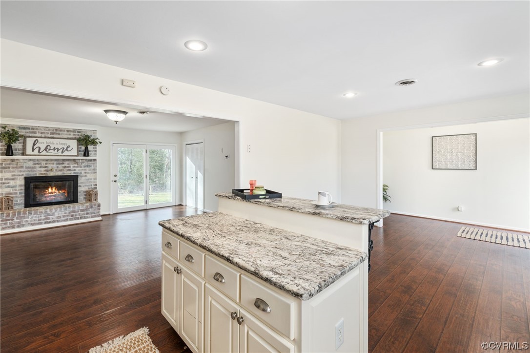 3612 Chesdin Boulevard Sutherland, VA 23885 - Photo 16 of 44 a kitchen with granite countertop a stove and a wooden floors