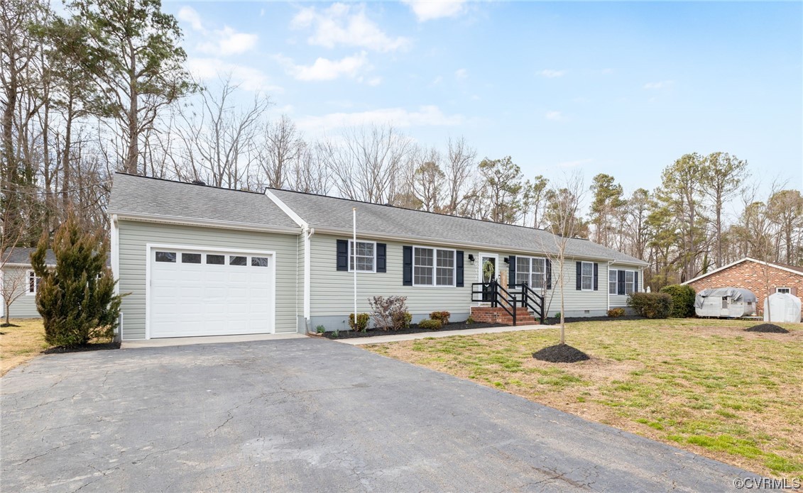 3612 Chesdin Boulevard Sutherland, VA 23885 - Photo 5 of 44 a front view of a house with a yard and more windows