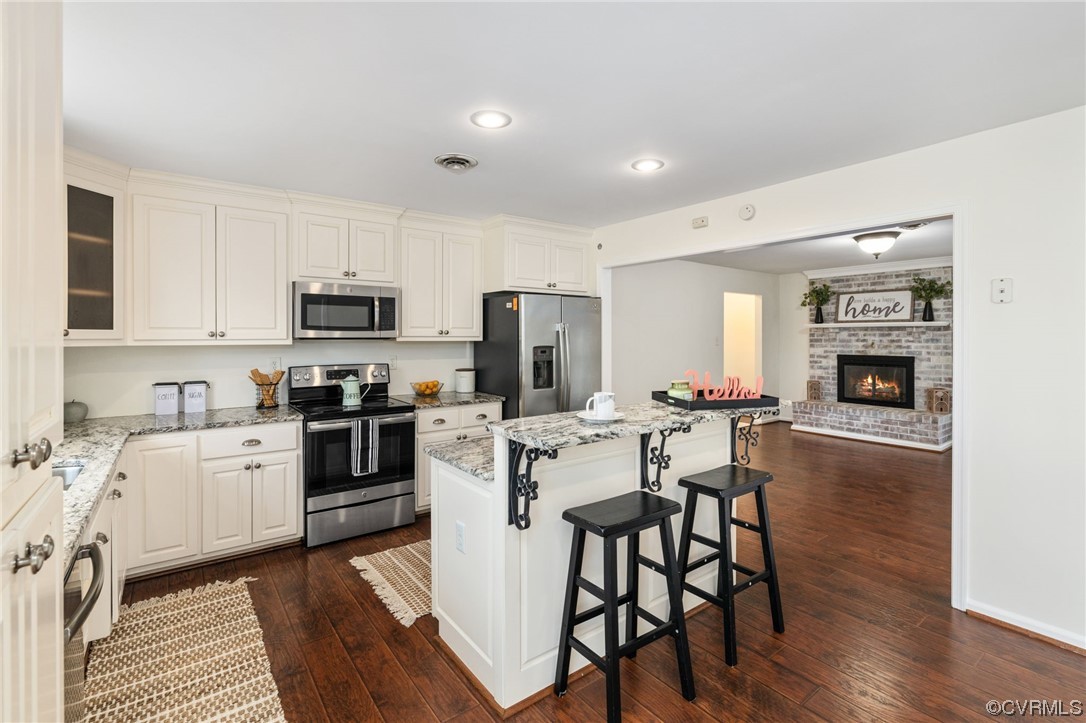 3612 Chesdin Boulevard Sutherland, VA 23885 - Photo 10 of 44 a kitchen with a table chairs refrigerator and cabinets