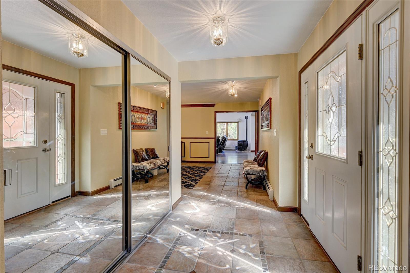 411 Spring Drive Pine, CO 80470 - Photo 11 of 40 a view of a hallway with living room and furniture