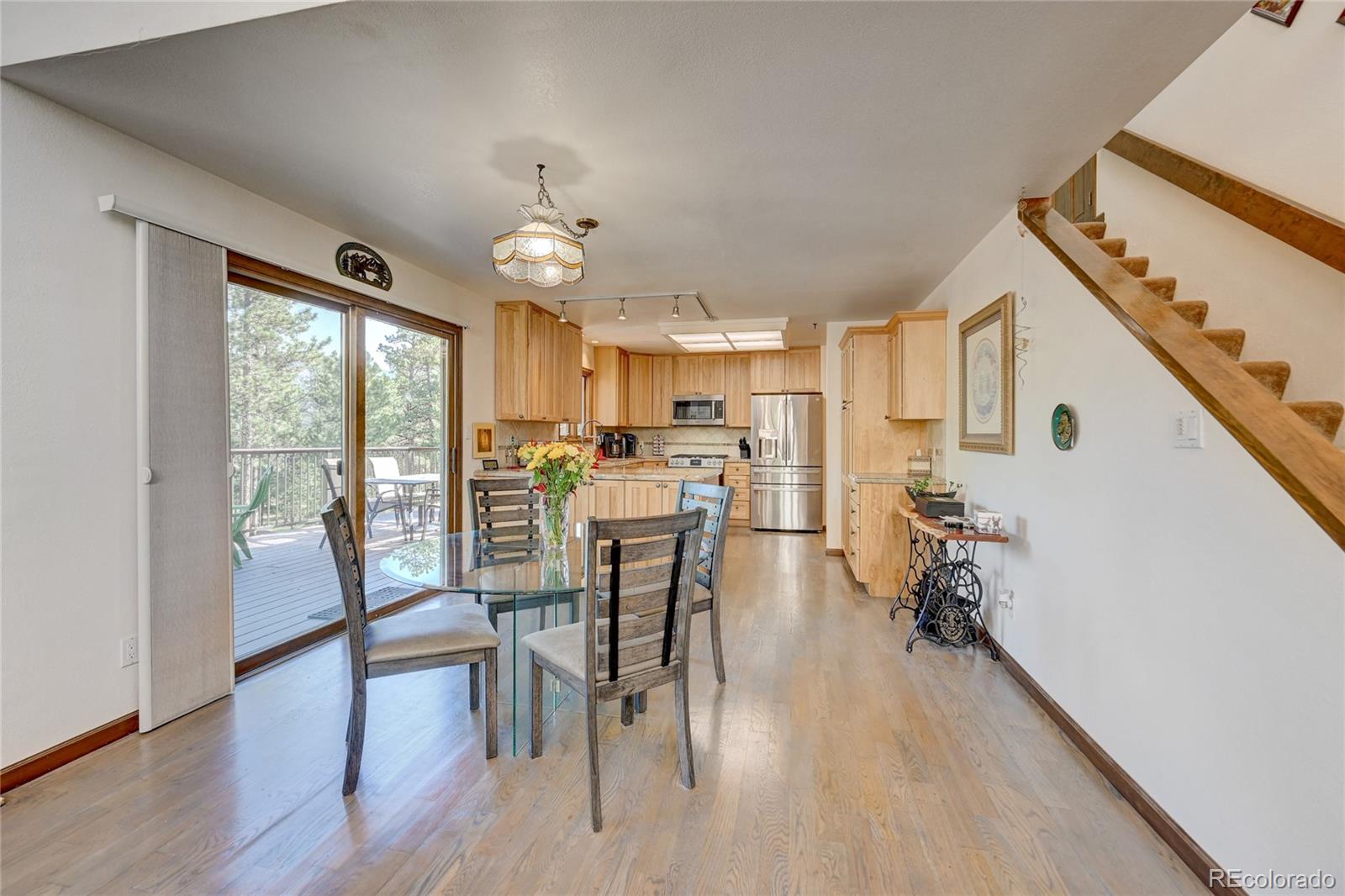411 Spring Drive Pine, CO 80470 - Photo 17 of 40 a view of a dining room with furniture window and wooden floor